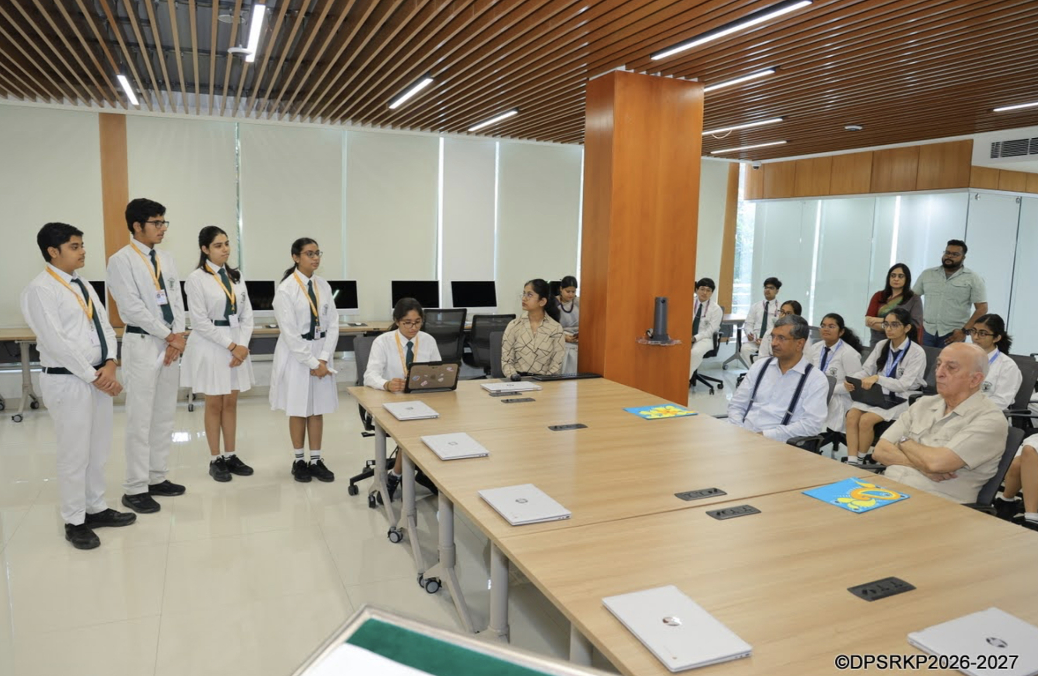 Another view of the team presenting to guests and students