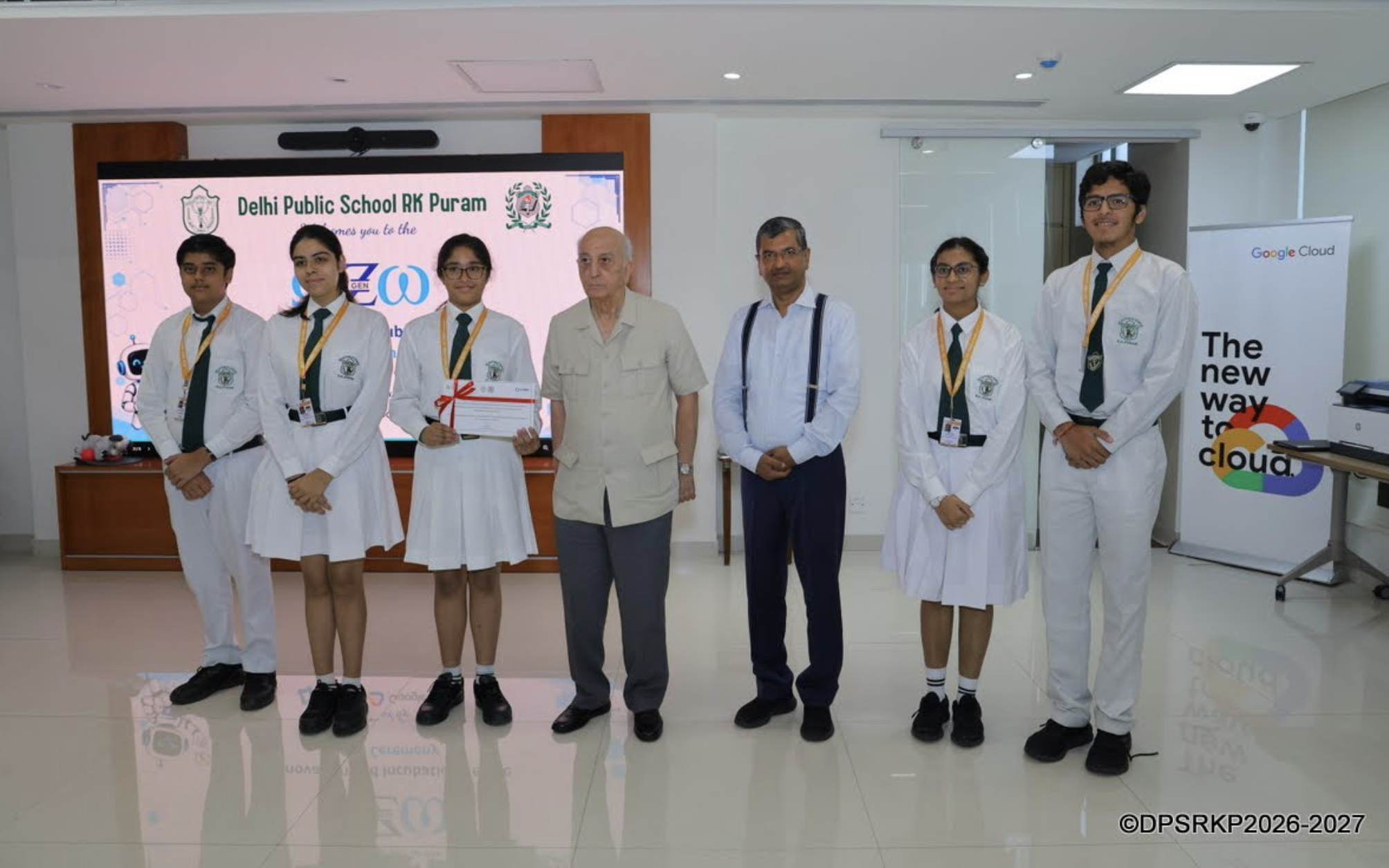 Team members with the guests of honour at the award ceremony, holding the certificate