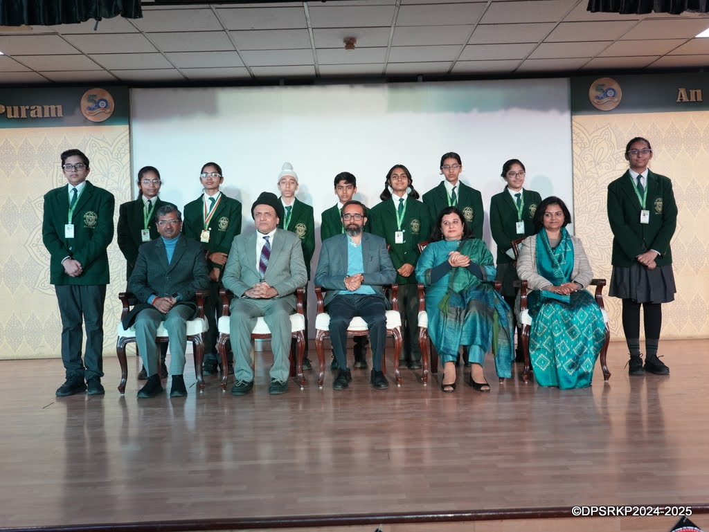 Scholar Badge recipients on stage with guests at the Class VII Scholar Badge Ceremony, DPS R. K. Puram