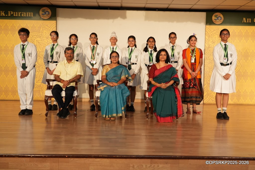 Scholar Badge recipients on stage with guests at the Class VIII Scholar Badge Ceremony, DPS R. K. Puram